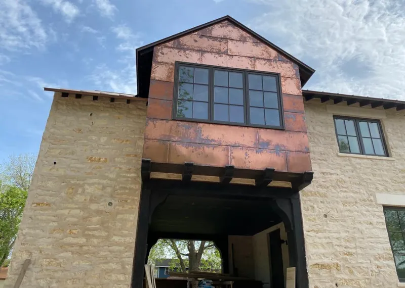 Copper metal panel facade on a stone building for Skylight Installation in Maple Heights